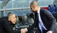(FILES) This file photo taken on April 21, 2012 shows Real Madrid's Portuguese coach Jose Mourinho (L) shaking hands with Barcelona's coach Josep Guardiola (R) during the Spanish League 