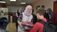 A student receiving school supplies at a Qatar Charity distribution centre in Tirana.