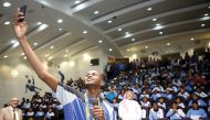 Star athlete Mutaz Essa Barshim takes a selfie with students and officials at the Aspire Academy yesterday. 