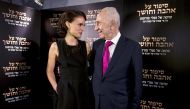 Director and actress Natalie Portman (L) speaks with former Israeli President Shimon Peres during a photocall for her film 