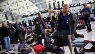 Climate activist group Reclaim the Power lie on the ground and carry luggage during a protest against airport expansion plans at Heathrow Airport in London, Britain October 1, 2016. REUTERS/Neil Hall

