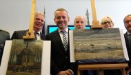 Axel Ruger (C), Director of the Van Gogh museum poses next to two recently recovered stolen paintings by late Dutch artist Vincent Van Gogh entitled 