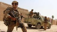 In this photograph taken on October 2, 2016, Afghan National Army commandos take position during a military operation in Helmand province. AFP / NOOR MOHAMMAD