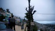 A couple enjoy the view while Hurricane Matthew approaches Port-au-Prince, Haiti, October 3, 2016. The text reads, 