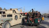 Afghan militia forces sit in a police vehicle amid ongoing fighting between Taliban militants and Afghan security forces in Kunduz on October 4, 2016. AFP / BASHIR KHAN SAFI