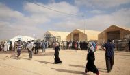 Syrian refugees wait at a UNHCR distribution centre in Za'atari refugee camp in Jordan. Photo: UNHCR/J. Tanner