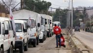 A Red Cross aid convoy waits on the outskirts of Madaya on Monday. (Louai Beshara/AFP/Getty Images)