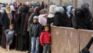 Syrian refugees stand in line as they wait for aid packages at Al Zaatari refugee camp in the Jordanian city of Mafraq, near the border with Syria, January 20, 2016. REUTERS/ Muhammad Hamed.