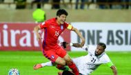 Iran’s Ashkan Dejgah (right) tackles South Korea’s Ki Sung-yueng during the 2018 World Cup qualifying football match at the Azadi Stadium in Tehran yesterday.