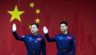 Chinese astronauts Jing Haipeng (L) and Chen Dong wave at a news conference before China launches the Shenzhou 11 manned spacecraft, in Jiuquan, China, October 16, 2016. China Daily/via REUTERS