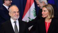 Iraqi Foreign Minister Ibrahim al-Jaafari (L) listens to EU foreign affairs chief Federica Mogherini after posing for a family photo at the end of an EU-Iraq Cooperation Council, at the European Council in Brussels on October 18, 2016. / AFP / EMMANUEL DU