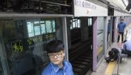 Security guards watch over the site where a man, 36, died after being caught in the gap between a train and a platform safety screen door at Gimpo International Airport Station on Wednesday morning. / Yonhap