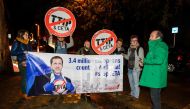 Protesters hold up a placard reading '3,4 million Europeans count on Wallonia - stop CETA' as a meeting on CETA (EU-Canada Comprehensive Economic and Trade Agreement) takes place at the Walloon parliament in Namur, Belgium, on October 18, 2016. The Europe