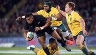 New Zealand's Julian Savea is tackled by Australia's Samu Kerevi (2nd R), Bernard Foley (R) and Israel Folau (bottom) during the third rugby Bledisloe Cup Test between the New Zealand All Blacks and Australia at Eden Park in Auckland on October 22, 2016.