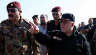Iraqi Prime Minister Haider al-Abadi (R) inspects Iraqi army's positions during the operation to retake Iraq's Mosul from Daesh, in Mosul, Iraq on October 19, 2016. (Iraqi Prime Ministry Press Office - Anadolu Agency)