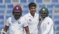 West Indies' batsman Devendra Bishoo (L) leaves the ground after his dismissal by Pakistani bowler Sohail Khan (C) on the third day of the second Test between Pakistan and the West Indies at the Sheikh Zayed Cricket Stadium in Abu Dhabi on October 23, 201
