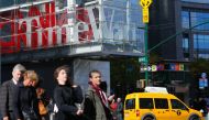Pedestrians walk past the Time Warner Inc. Center in New York on October 23, 2016. AT&T unveiled a mega-deal for Time Warner that would transform the telecom giant into a media-entertainment powerhouse positioned for a sector facing major technology chang