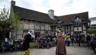 Tourists watch actors perform at the house where William Shakespeare was born during celebrations to mark the 400th anniversary of the playwright's death in Stratford-Upon-Avon, Britain, April 23, 2016. (REUTERS/Dylan Martinez) 