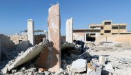 A boy inspects a damaged site after shelling in the rebel held town of Hass, south of Idlib province, Syria October 26, 2016. (REUTERS/Ammar Abdullah)