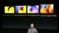 Phil Schiller, senior vice president of worldwide marketing at Apple, speaks under a graphic of the new MacBook Pro laptop computers during an Apple media event in Cupertino, California, U.S. October 27, 2016. (REUTERS/Beck Diefenbach)