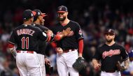 Cleveland Indians starting pitcher Corey Kluber (middle) is congratulated by teammates as he waits to be relieved in the 7th inning against the Chicago Cubs in game one of the 2016 World Series at Progressive Field. Ken Blaze-USA TODAY Sports