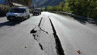 A picture shows cracks on the road outside the center of Norcia after a 6.6 magnitude earthquake on October 30, 2016.  AFP / ALBERTO PIZZOLI
