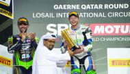 British rider Kyle Smith of CIA Landlord Insurance Honda Team receives the winner's trophy from QMMF President Abdulrahman Al Mannai during the presentation ceremony at the Losail International Circuit yesterday.
