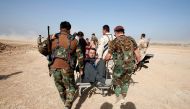 Kurdish Peshmerga fighters carry a wheelchair-bound man, Abbas Ali, 42, after he escaped with his wife and four children from the Islamic State-controlled village of Abu Jarboa, Iraq October 31, 2016. REUTERS/Azad Lashkari TPX IMAGES OF THE DAY
