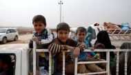 A displaced Iraqi family flees after escaping from Islamic State controlled village of Abu Jarboa during clashes with IS militants near Mosul, Iraq November 1, 2016. REUTERS/Ahmed Jadallah
