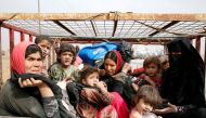 Displaced Iraqi women and children sit at the back of a vehicle after escaping from Islamic State controlled village of Abu Jarboa during clashes with IS militants near Mosul, Iraq November 1, 2016. REUTERS/Ahmed Jadallah