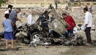 Egyptian policemen inspect the wreckage of a car after a bomb exploded in the eastern Nasr City district of the Egyptian capital Cairo on November 4, 2016. An Egyptian judge in one of the trials of ousted Islamist president Mohamed Morsi escaped unharmed 