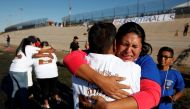 Relatives separated by deportation and immigration hug at the border during a brief reunification meeting at the banks of the Rio Bravo, a natural border between U.S. and Mexico, October 29, 2016. REUTERS/Jose Luis Gonzalez/File Photo