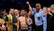 Manny Pacquiao celebrates his victory over WBO welterweight champion Jessie Vargas following their title fight at the Thomas & Mack Center in Las Vegas, Nevada, U.S., November 5, 2016. Referee Kenny Bayless is at right. Reuters/Las Vegas Sun/Steve Marcus