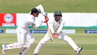 Sri Lanka batsman Dhananjaya de Silva (L) is in action as Brian Chari escapes a ball during the first day of the second cricket Test match between Sri Lanka and hosts Zimbabwe at the Harare Sports club, on November 6, 2016. (AFP / Jekesai Njikizana)