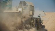 A convoy of the Iraqi army's 9th armoured division drives through an open field to approach the eastern Al-Intissar neighbourhood of Mosul on November 6, 2016, during a military operation to retake the main hub city from the Islamic State (IS) group jihad