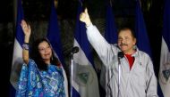 Daniel Ortega, Nicaragua's current president and presidential candidate from the ruling Sandinista National Liberation Front, shows his ink stained thumb to the media beside his wife Rosario Murillo after they casting their vote at a polling station durin