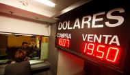 A board displaying the exchange rates of Mexican peso against the US dollar is seen at a foreign exchange house in Ciudad Juarez, Mexico, November 8, 2016. (REUTERS/Jose Luis Gonzalez)