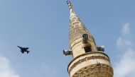 A Turkish Air Force F-16 fighter flies over a minaret after it took off from Incirlik air base in Adana, Turkey. Reuters/File Photo