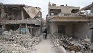  A Syrian man walks between destroyed buildings in the rebel-held town of Douma on the eastern outskirts of the capital Damascus on November 13, 2016. Douma, the largest town in the Eastern Ghouta area with more than 100,000 residents, is surrounded and r