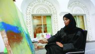 An artist painting for the exhibition.