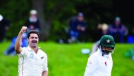 New Zealand's Colin de Grandhomme (left) celebrates after bowling out Pakistan's Azhar Ali during day two of their first Test match at the Hagley Park in Christchurch yesterday.