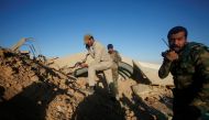 Members of the Shi'ite Badr Organisation fighters take cover behind a berm during a battle with Islamic State militants at the airport of Tal Afar west of Mosul, Iraq, November 20, 2016. REUTERS/Khalid al Mousily
