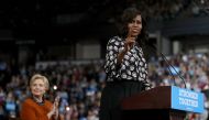 Hillary Clinton looks on as Michelle Obama speaks at Wake Forest University on October 27, 2016 in Winston-Salem, North Carolina (Justin Sullivan / Getty Images / AFP) 
