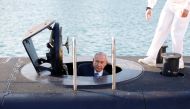 Israeli Prime Minister Benjamin Netanyahu climbs out after a visit inside the Rahav, the fifth submarine in the fleet, after it arrived in the Haifa port January 12, 2016. REUTERS/Baz Ratner
