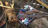 Belongings are caught in branches and landslide mud on November 22, 2016 in the village of Ouakaya in the Houailou area, around 235 kilometres (150 miles) northwest of the capital Noumea, on the eastern coast of New Caledonia, after rain battered the area