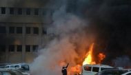 A firefighter tries to extinguish burning vehicles after an explosion outside the governor's office in the southern city of Adana, Turkey, November 24, 2016. Ihlas News PHOTO: REUTERS.