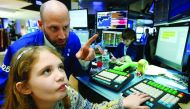 Specialist trader Meric Greenbaum works with his daughter on the floor of the New York Stock Exchange (NYSE) in New York City, U.S., November 25, 2016. REUTERS/Brendan McDermid