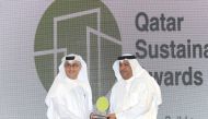A senior official from Qatar Charity receives the award.