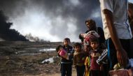 Iraqi families who were displaced by the ongoing operation by Iraqi forces against jihadists of the Islamic State group to retake the city of Mosul, are seen near Qayyarah, south of Mosul, on October 29, 2016. Iraqi paramilitary forces launched an operati
