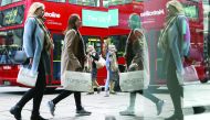 Pedestrians carrying shopping bags in Oxford Street in central London. 
